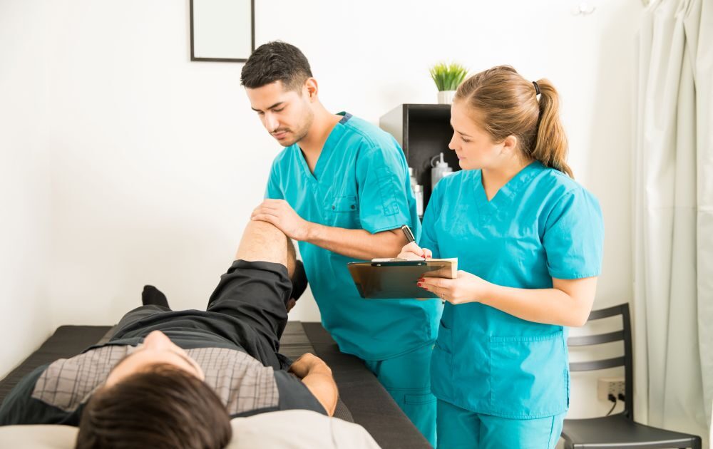 pelvic floor physiotherapy session with physiotherapist guiding patient exercises